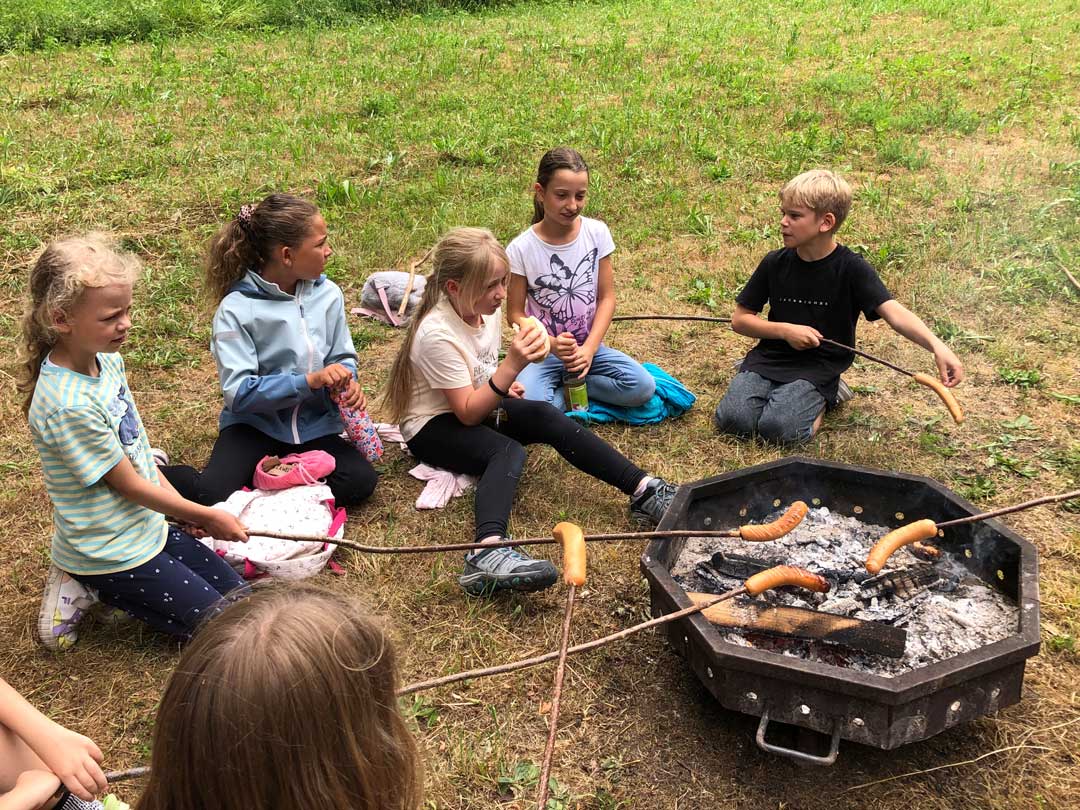 Wald‑3 Kinder der FES Heidenheim Grundschule braten am Waldtag "Würschdle" über dem Feuer
